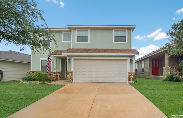 traditional-style house with driveway, a front yard, stone siding, stucco siding, and a garage