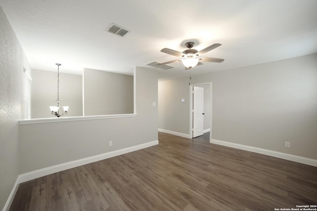 spare room with dark wood finished floors, baseboards, and visible vents