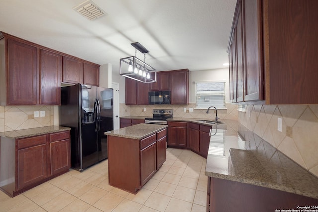 kitchen with a sink, a kitchen island, light tile patterned floors, visible vents, and black appliances
