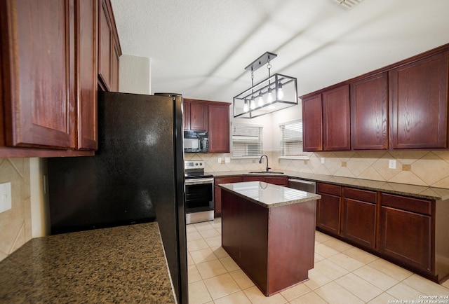 kitchen featuring reddish brown cabinets, a sink, a center island, black appliances, and decorative backsplash