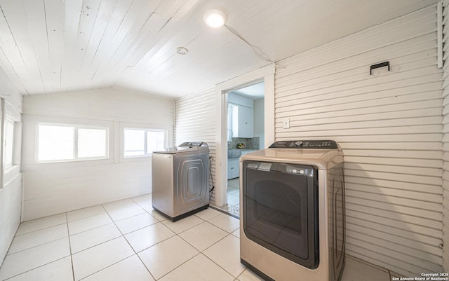 laundry room featuring light tile patterned floors, separate washer and dryer, wood ceiling, wooden walls, and laundry area