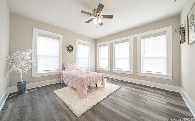 bedroom featuring a ceiling fan, dark wood-type flooring, and baseboards