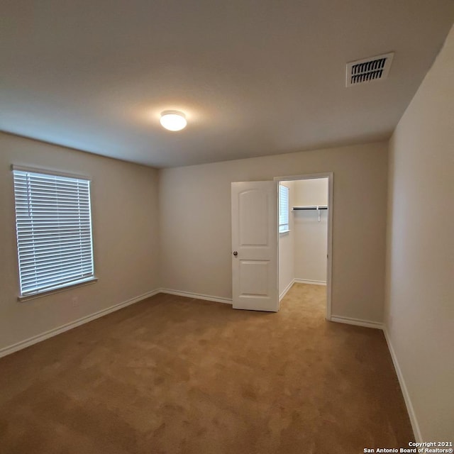 8062 Halo Cir, San Antonio, TX 78252 - carpeted spare room featuring baseboards and visible vents