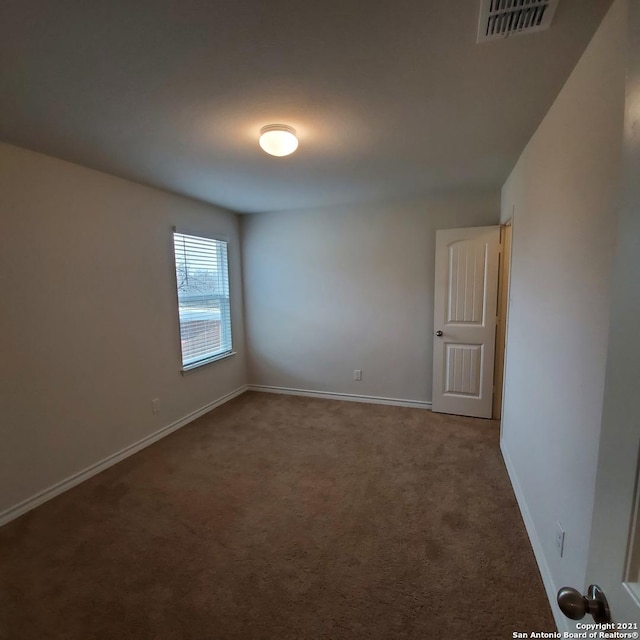 8062 Halo Cir, San Antonio, TX 78252 - carpeted spare room featuring baseboards and visible vents