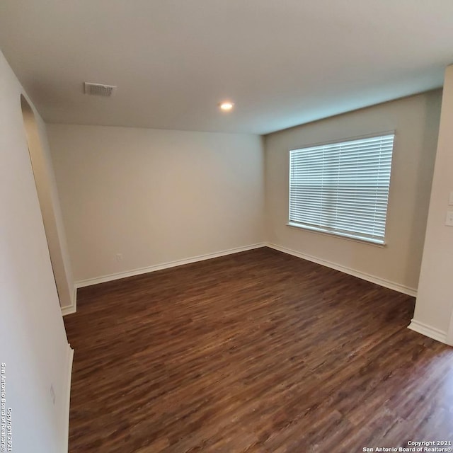 8062 Halo Cir, San Antonio, TX 78252 - unfurnished room with baseboards, visible vents, recessed lighting, and dark wood-style flooring
