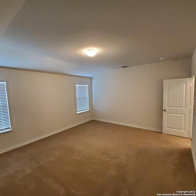 8062 Halo Cir, San Antonio, TX 78252 - spare room with baseboards, visible vents, and carpet