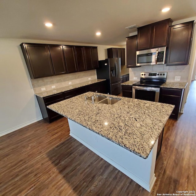 8062 Halo Cir, San Antonio, TX 78252 - kitchen featuring dark brown cabinetry, backsplash, a sink, stainless steel appliances, and dark wood-type flooring