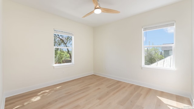 unfurnished room featuring baseboards, a healthy amount of sunlight, light wood finished floors, and ceiling fan