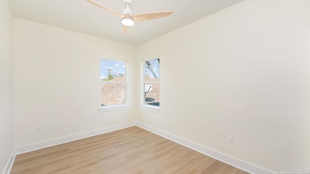unfurnished room featuring baseboards, light wood-style floors, and ceiling fan