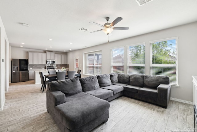 13850 Cohan Way, San Antonio, TX 78253 - living room with baseboards, visible vents, light wood-style floors, and a ceiling fan