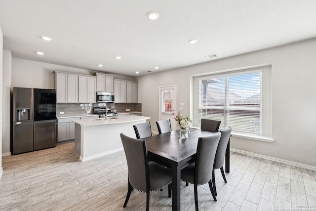 13850 Cohan Way, San Antonio, TX 78253 - dining space featuring wood tiled floor, visible vents, recessed lighting, and baseboards