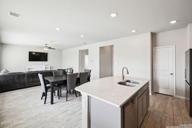 13850 Cohan Way, San Antonio, TX 78253 - kitchen featuring wood finish floors, a sink, ceiling fan, dishwasher, and visible vents
