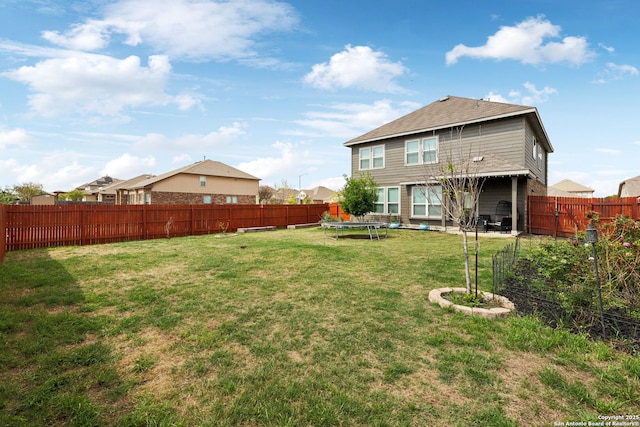 13850 Cohan Way, San Antonio, TX 78253 - view of yard featuring a trampoline and a fenced backyard
