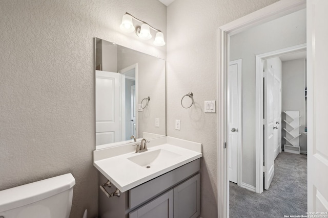 13850 Cohan Way, San Antonio, TX 78253 - bathroom featuring toilet, vanity, and a textured wall