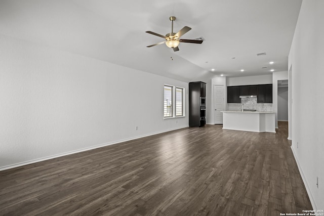 10281 Bartenheim Dr, Schertz, TX 78154 - unfurnished living room with ceiling fan, dark wood-style floors, recessed lighting, baseboards, and lofted ceiling