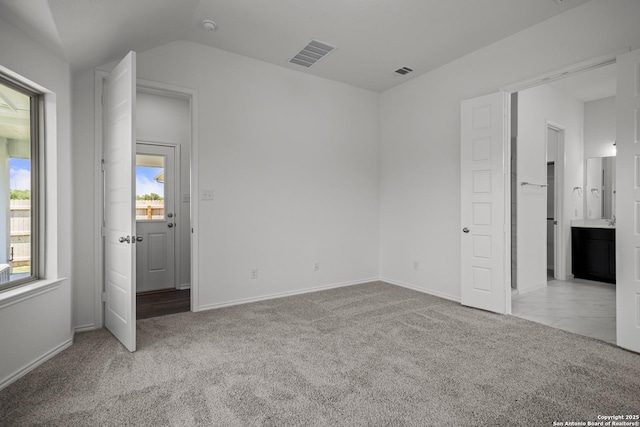10281 Bartenheim Dr, Schertz, TX 78154 - unfurnished bedroom featuring carpet, baseboards, lofted ceiling, and ensuite bath