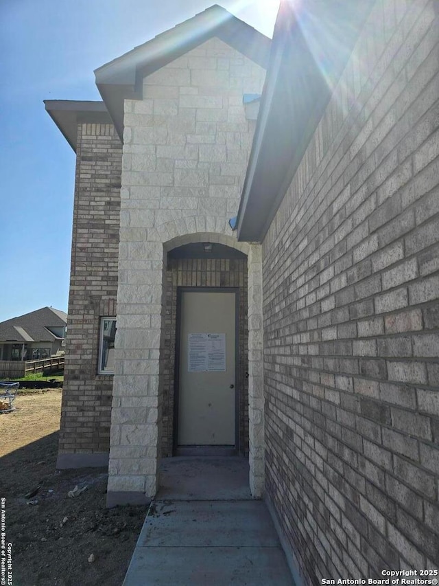 entrance to property featuring stone siding
