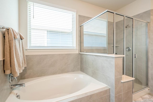 bathroom with a garden tub and a stall shower