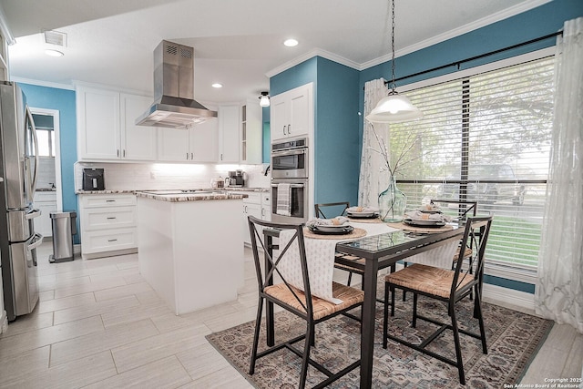 kitchen featuring stainless steel appliances, tasteful backsplash, white cabinetry, exhaust hood, and a center island