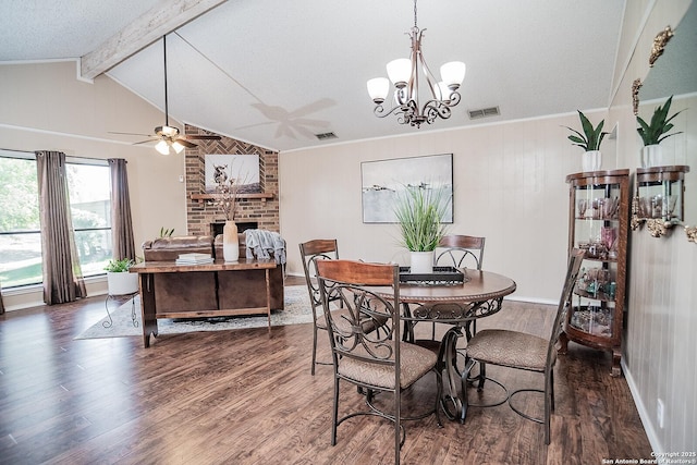 dining area featuring ceiling fan with notable chandelier, wood finished floors, vaulted ceiling with beams, and visible vents