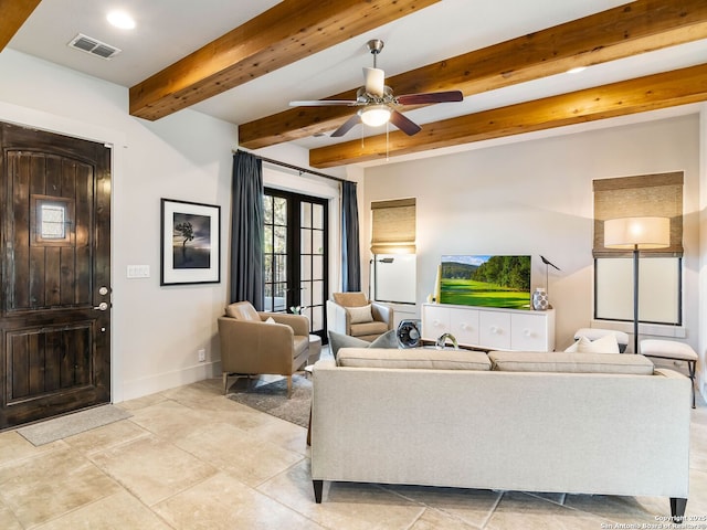 living area with baseboards, ceiling fan, visible vents, and beam ceiling