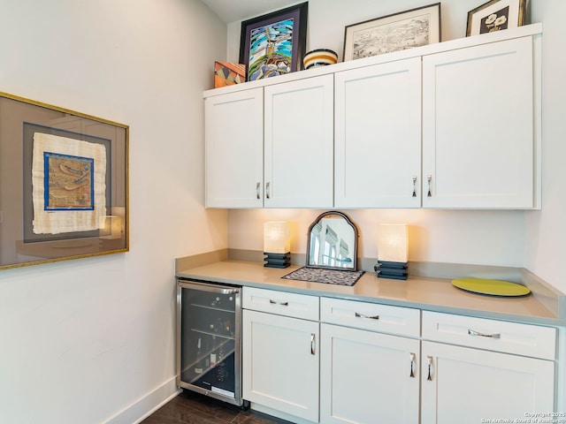kitchen with white cabinetry, light countertops, and beverage cooler