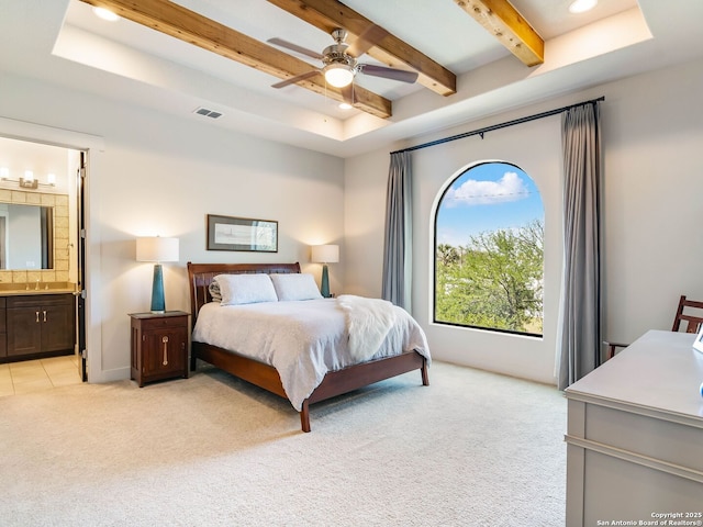 bedroom featuring visible vents, recessed lighting, beam ceiling, ensuite bath, and light colored carpet