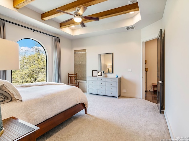 bedroom with carpet flooring, visible vents, beamed ceiling, and a raised ceiling