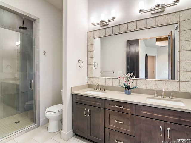 bathroom with a shower stall, double vanity, toilet, and a sink