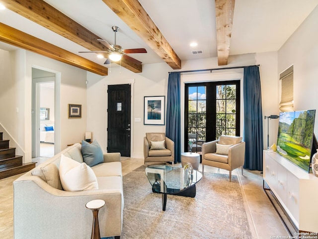 living area featuring stairs, visible vents, beam ceiling, and ceiling fan