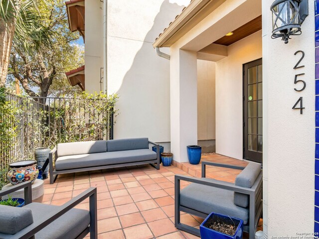 view of patio with an outdoor hangout area and fence