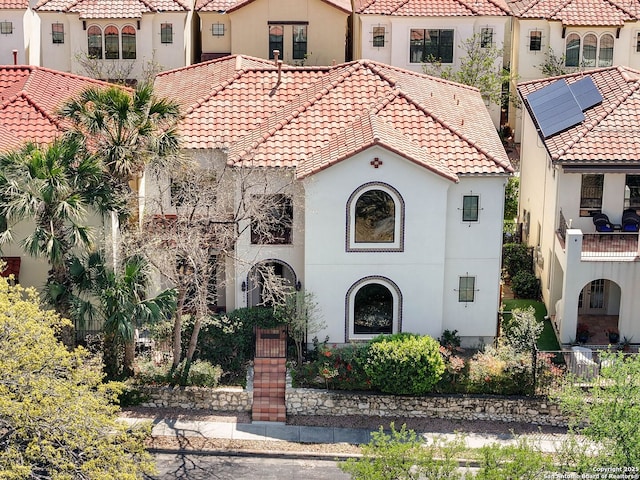 mediterranean / spanish-style house featuring a tile roof and stucco siding