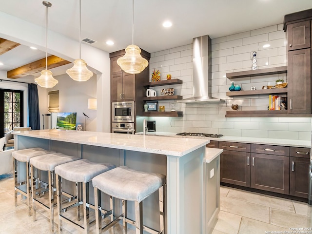 kitchen featuring wall chimney range hood, appliances with stainless steel finishes, open shelves, and decorative backsplash