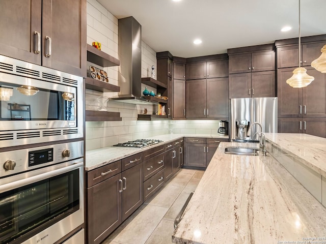kitchen featuring a sink, backsplash, open shelves, appliances with stainless steel finishes, and dark brown cabinets