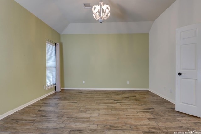 7609 Highland Park, San Antonio, TX 78250 - unfurnished room featuring a chandelier, wood finished floors, vaulted ceiling, and baseboards