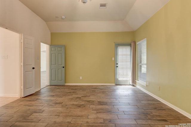 7609 Highland Park, San Antonio, TX 78250 - spare room featuring lofted ceiling, wood finished floors, and baseboards