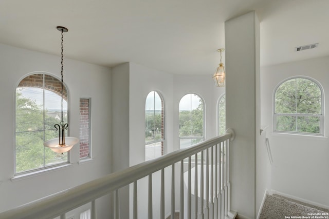 7609 Highland Park, San Antonio, TX 78250 - hall with healthy amount of natural light, baseboards, an upstairs landing, and carpet