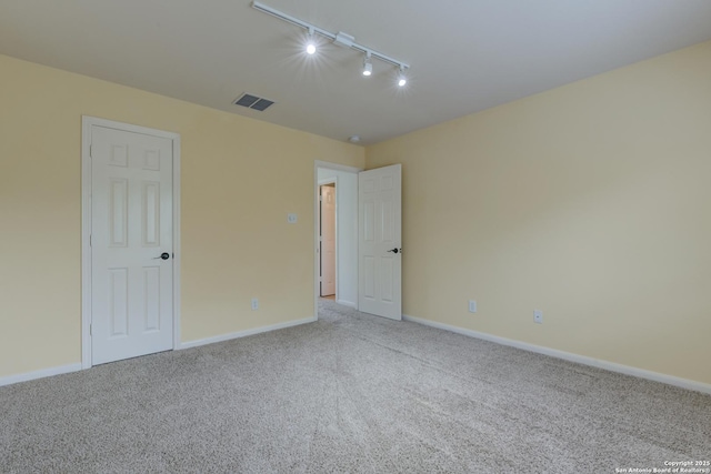 7609 Highland Park, San Antonio, TX 78250 - carpeted empty room featuring rail lighting and baseboards