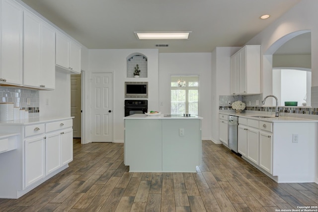 7609 Highland Park, San Antonio, TX 78250 - kitchen with appliances with stainless steel finishes, a sink, backsplash, light countertops, and dark wood-style floors