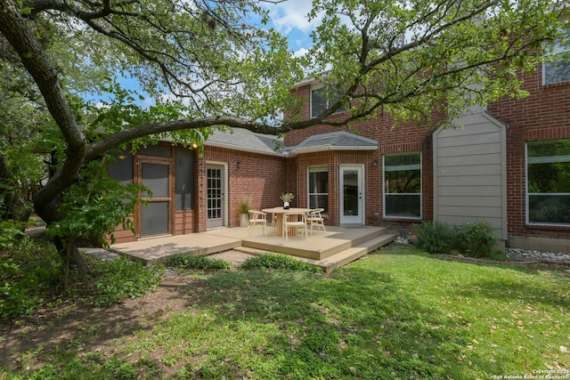 7609 Highland Park, San Antonio, TX 78250 - rear view of house with a wooden deck, a yard, and brick siding