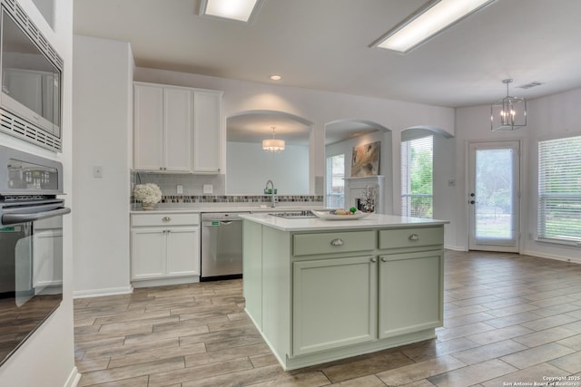 7609 Highland Park, San Antonio, TX 78250 - kitchen featuring green cabinetry, appliances with stainless steel finishes, a chandelier, wood tiled floors, and recessed lighting