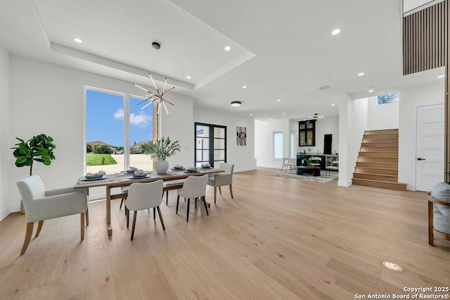 303 Pleasant Knl, San Antonio, TX 78260 - dining area with stairs, light wood-style flooring, a tray ceiling, a chandelier, and recessed lighting