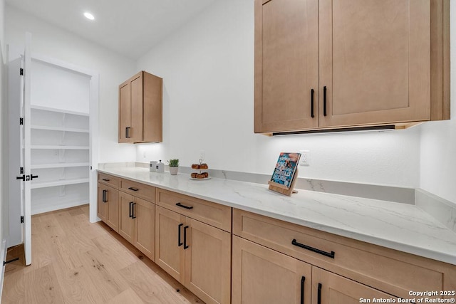 303 Pleasant Knl, San Antonio, TX 78260 - kitchen featuring light wood-type flooring, light stone countertops, light brown cabinetry, and recessed lighting