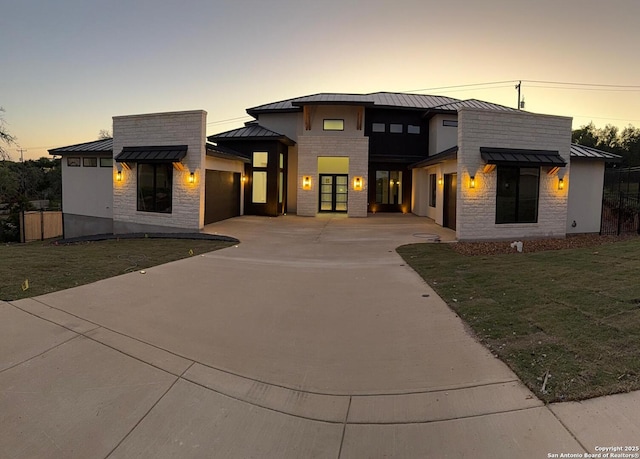 303 Pleasant Knl, San Antonio, TX 78260 - contemporary home with a standing seam roof, metal roof, concrete driveway, a garage, and stone siding