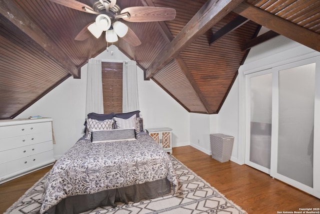 bedroom featuring lofted ceiling with beams, baseboards, wood finished floors, a ceiling fan, and wooden ceiling