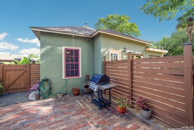 exterior space featuring a grill and fence