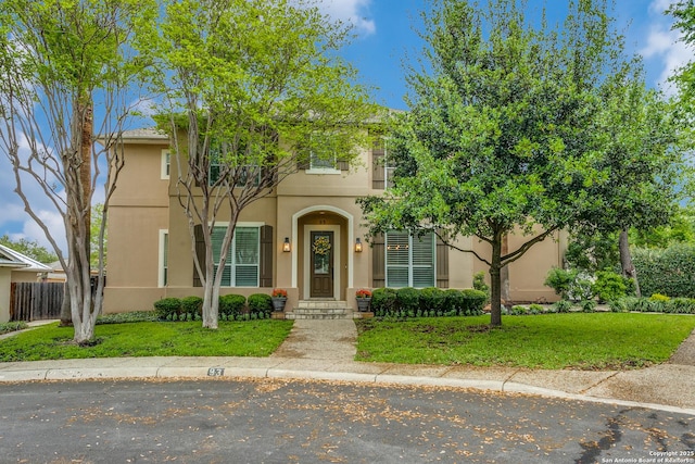 93 Bristol Grn, San Antonio, TX 78209 - view of front of house featuring a balcony, a front lawn, stucco siding, and fence