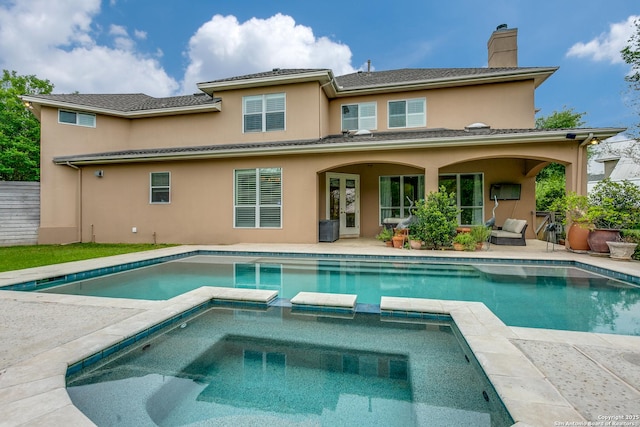 93 Bristol Grn, San Antonio, TX 78209 - back of house with a chimney, french doors, a patio, stucco siding, and a pool with connected hot tub