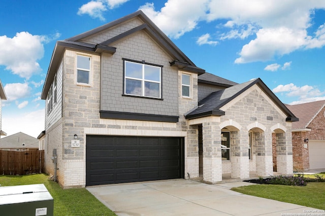 5230 Anzueto, San Antonio, TX 78261 - view of front facade with stone siding, driveway, fence, and an attached garage