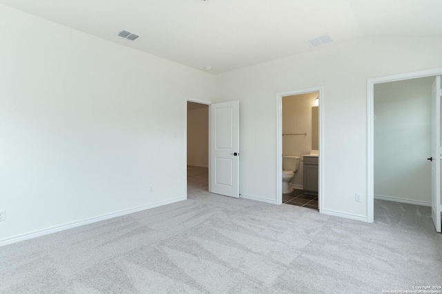 5230 Anzueto, San Antonio, TX 78261 - unfurnished bedroom featuring carpet flooring, a walk in closet, lofted ceiling, and visible vents